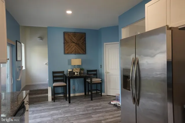 a kitchen with a refrigerator and furniture