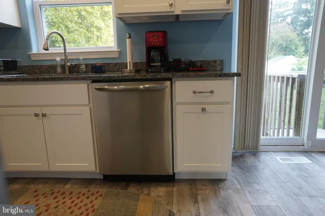a kitchen with a sink and wooden cabinets