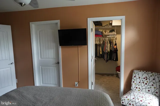 a bedroom with a bed and a couch