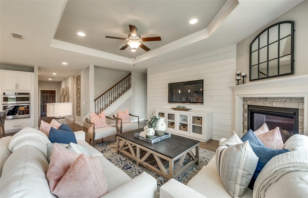 1608 Kendell Street Anna, TX 75409 - Photo 14 of 28 a living room with furniture a fireplace and a flat screen tv