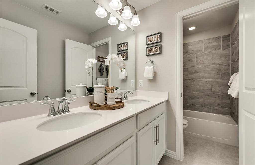 1608 Kendell Street Anna, TX 75409 - Photo 23 of 28 a bathroom with a sink double vanity granite tub and a mirror