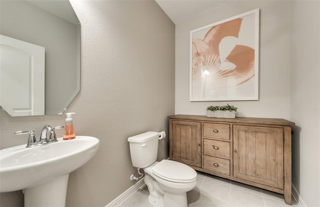 1608 Kendell Street Anna, TX 75409 - Photo 5 of 28 a bathroom with a toilet sink and mirror