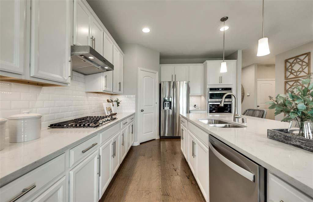 1608 Kendell Street Anna, TX 75409 - Photo 9 of 28 a kitchen with stainless steel appliances a sink stove and cabinets