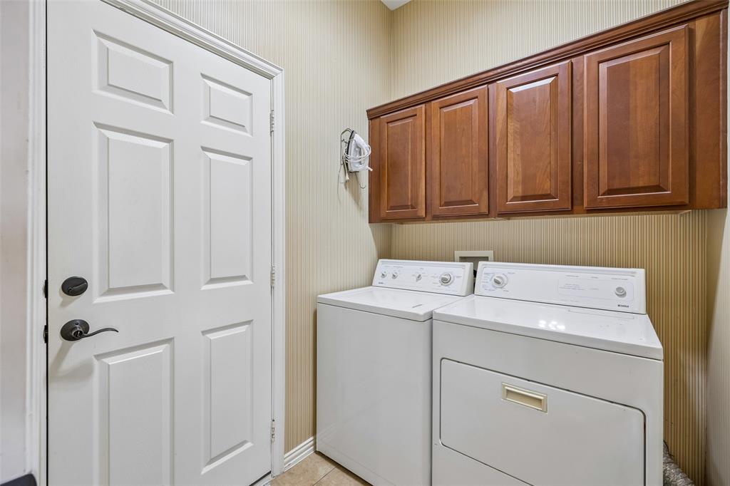 9221 Perimeter Street Denton, TX 76207 - Photo 26 of 36 a view of storage and utility room with washer and dryer