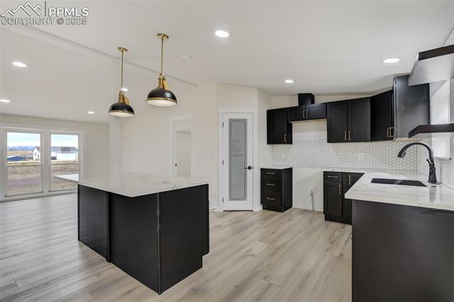 5455 Prospero Road Peyton, CO 80831 - Photo 11 of 47 Granite Countertops, New Cabinetry with Gold Hardware