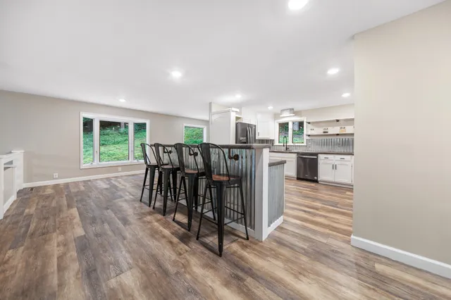 an empty room with a window and a ceiling fan