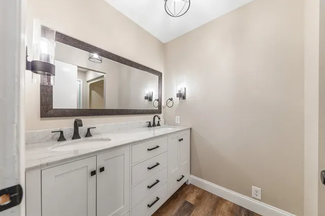 a kitchen with granite countertop white cabinets white stainless steel appliances with a sink and dishwasher
