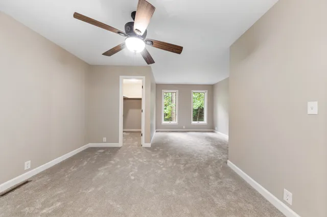 a view of a chair and tables in backyard of the house