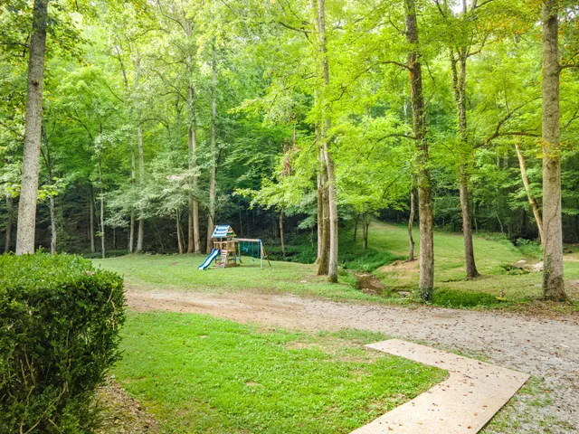 a view of a house with a backyard
