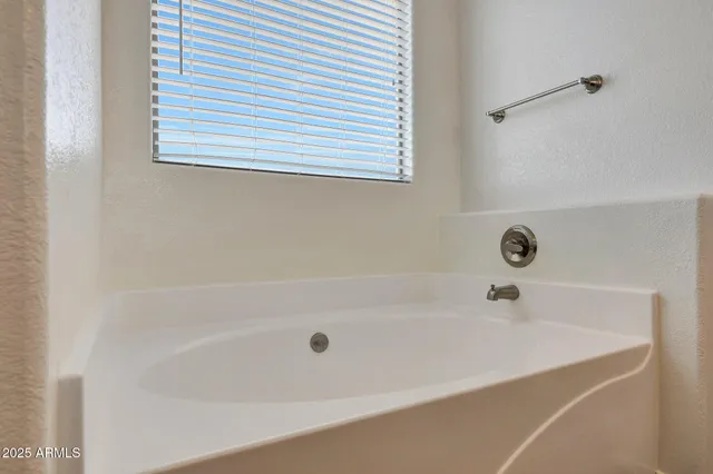 a white bath tub sitting next to a white sink