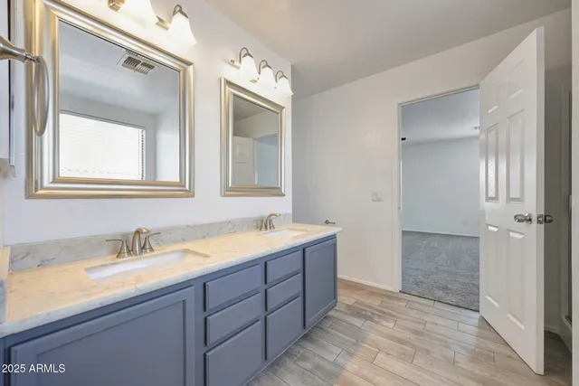 a spacious bathroom with a double vanity sink mirror and