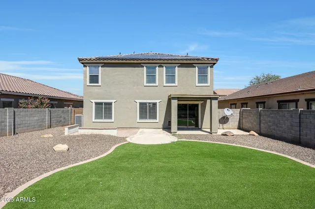 an aerial view of a house with a yard