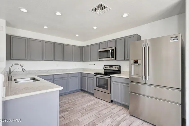a kitchen with a refrigerator stove and sink