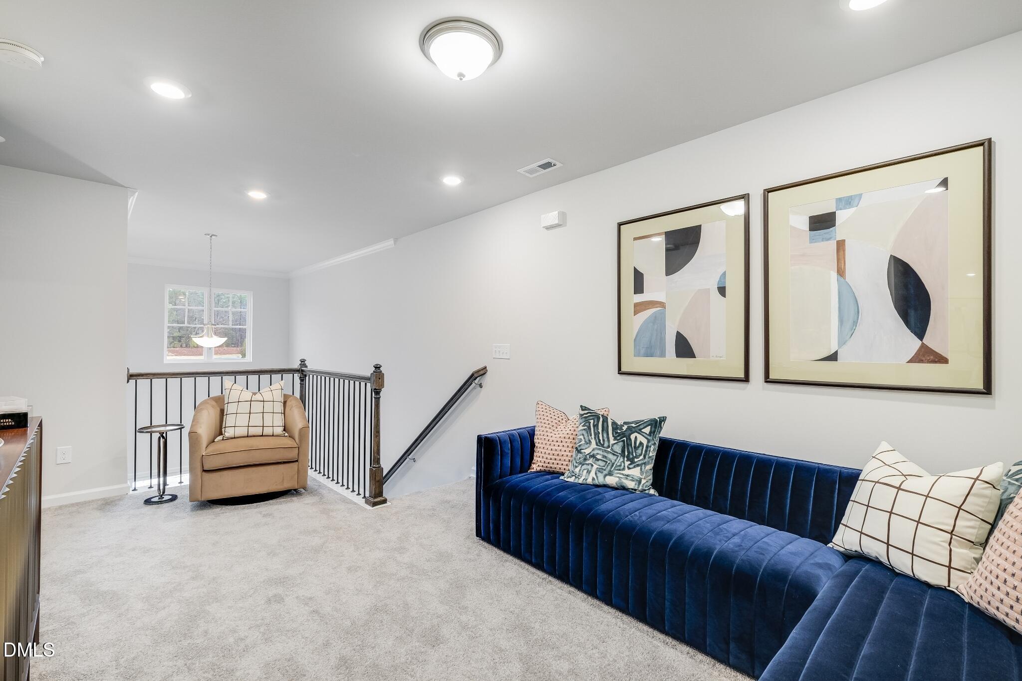 1028 Red Finch Way Angier, NC 27501 - Photo 12 of 40 a living room with furniture and a painting on the wall