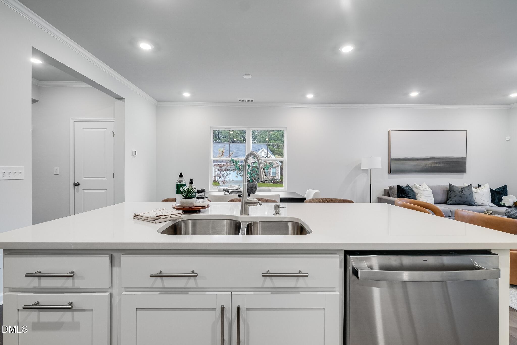 1028 Red Finch Way Angier, NC 27501 - Photo 14 of 40 a view of a kitchen counter space a sink wooden floor and furniture