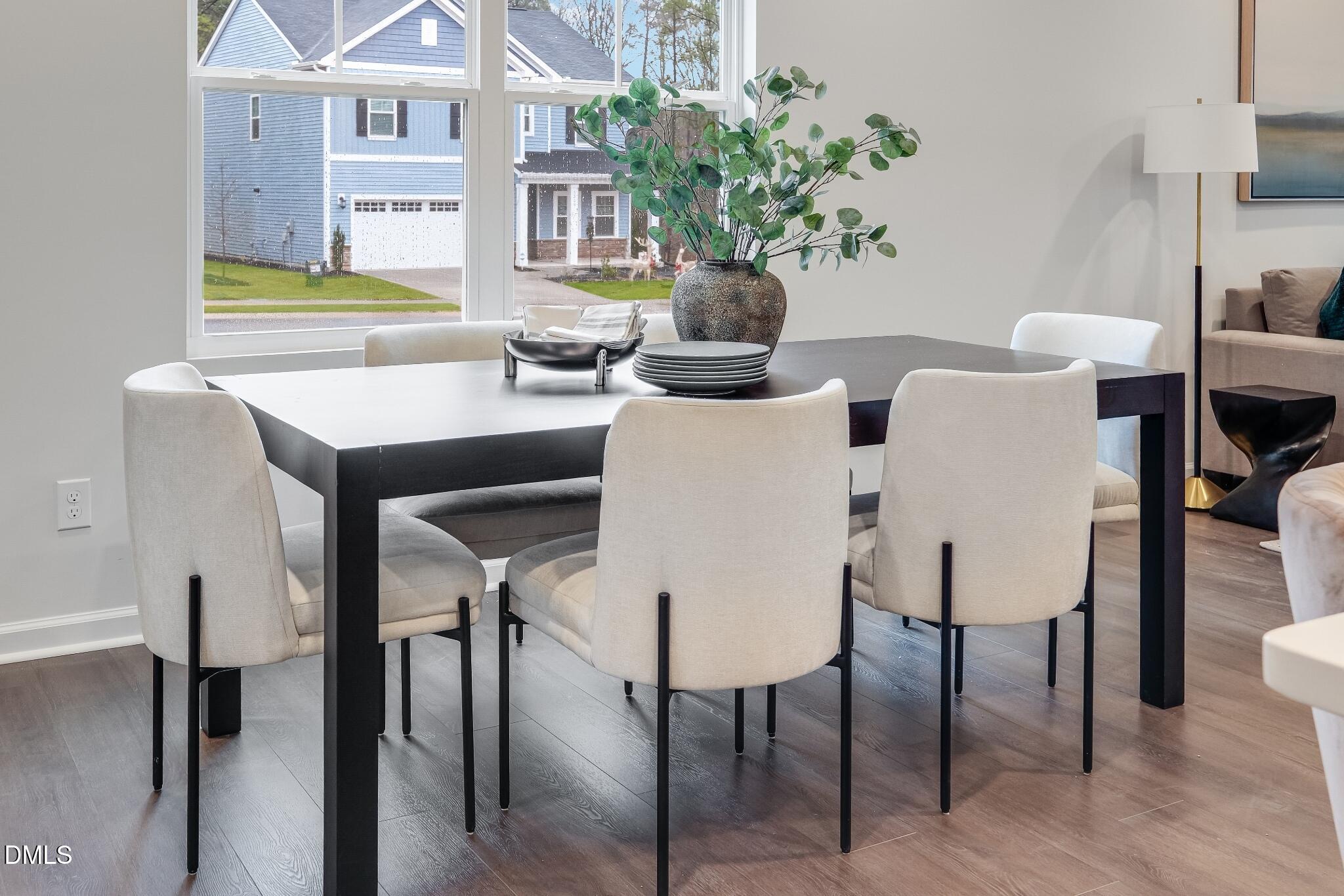 1028 Red Finch Way Angier, NC 27501 - Photo 19 of 40 a view of a dining room with furniture and wooden floor