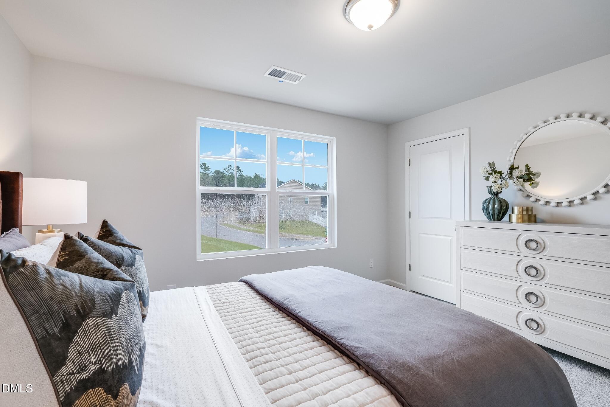 1028 Red Finch Way Angier, NC 27501 - Photo 25 of 40 a bedroom with a bed and wooden floor