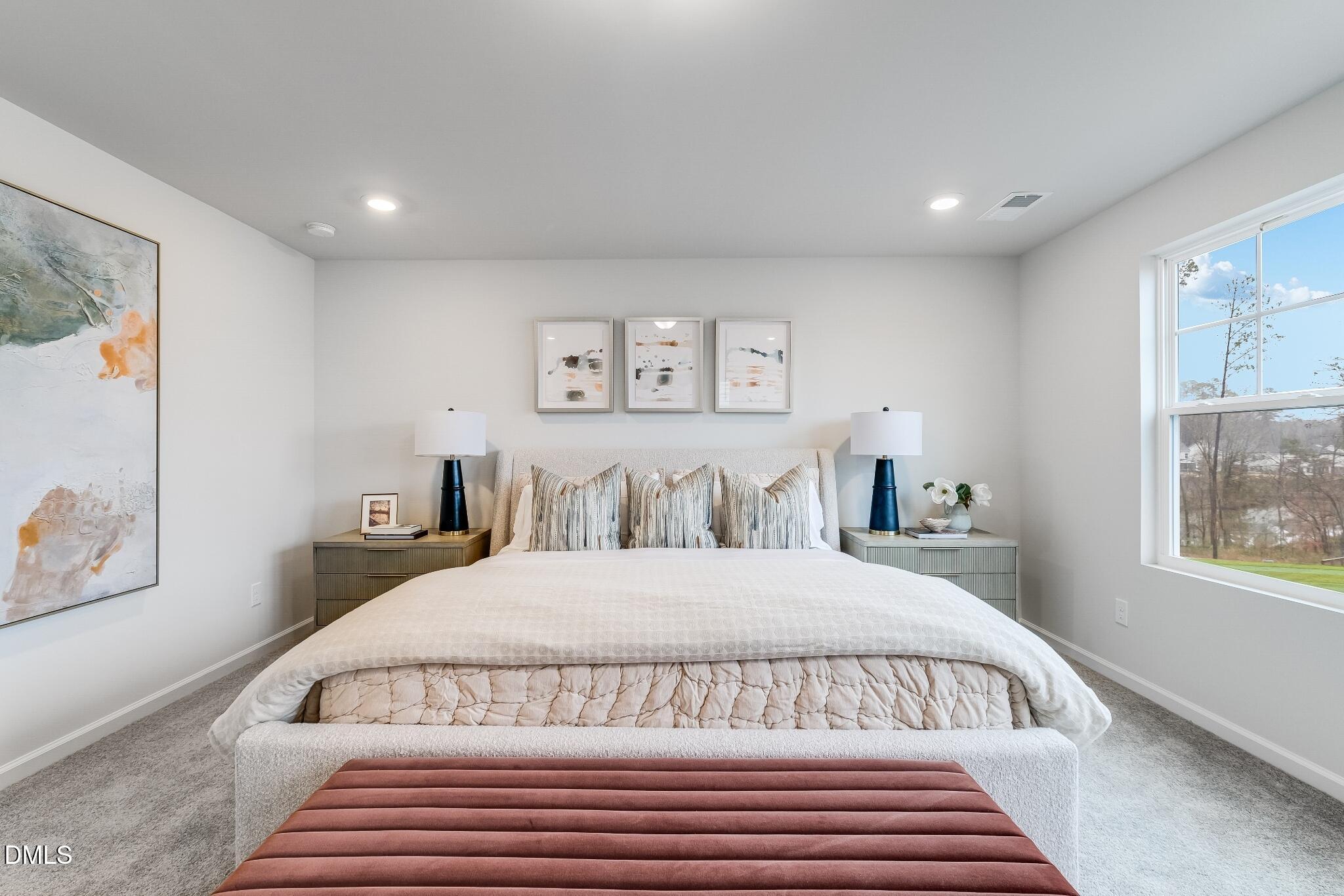 1028 Red Finch Way Angier, NC 27501 - Photo 27 of 40 a bedroom with a large bed and a window