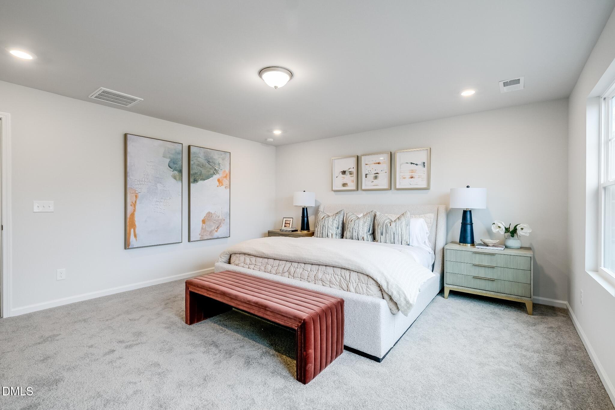 1028 Red Finch Way Angier, NC 27501 - Photo 28 of 40 a spacious bedroom with a bed and a window