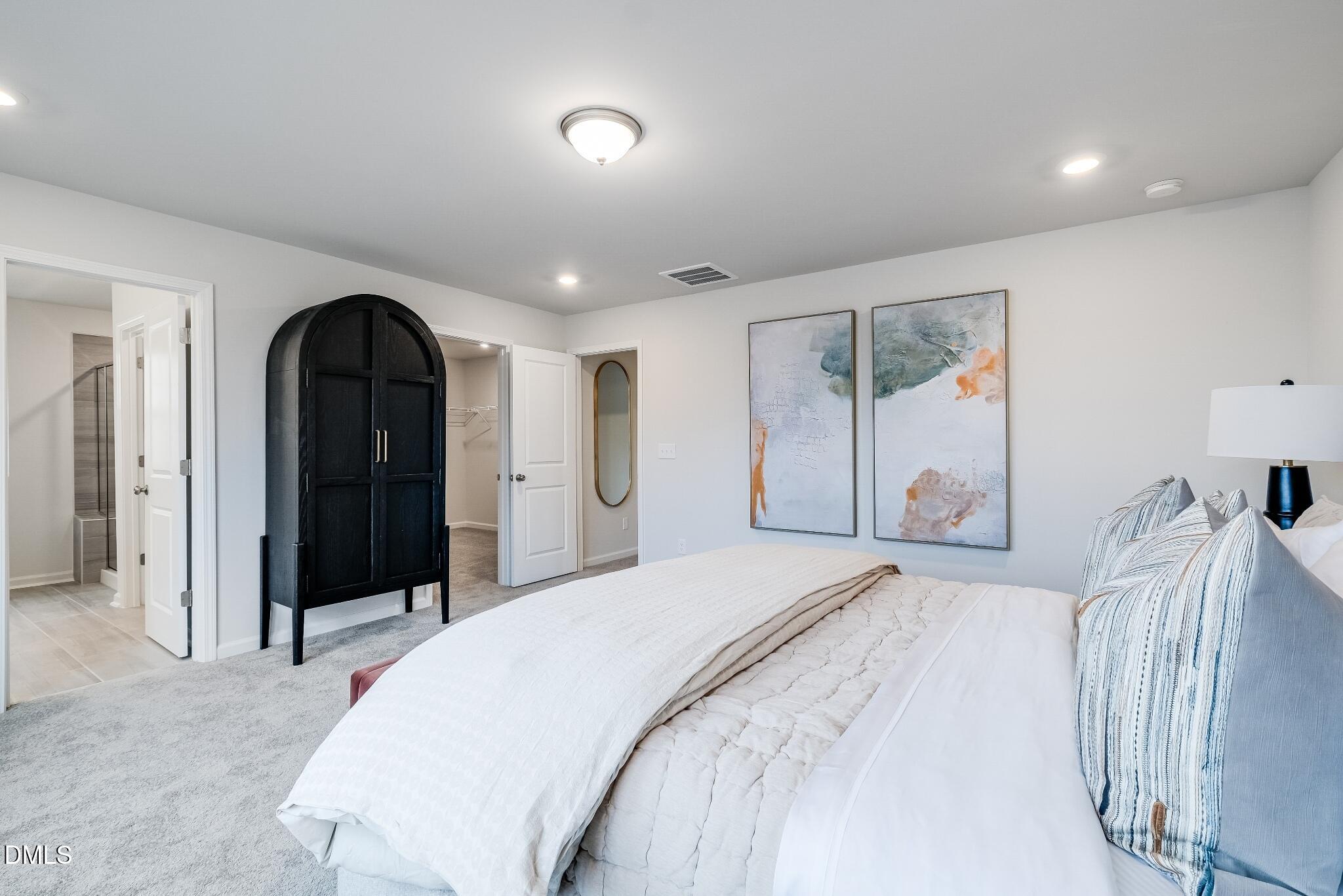 1028 Red Finch Way Angier, NC 27501 - Photo 29 of 40 a spacious bedroom with a bed and a dresser