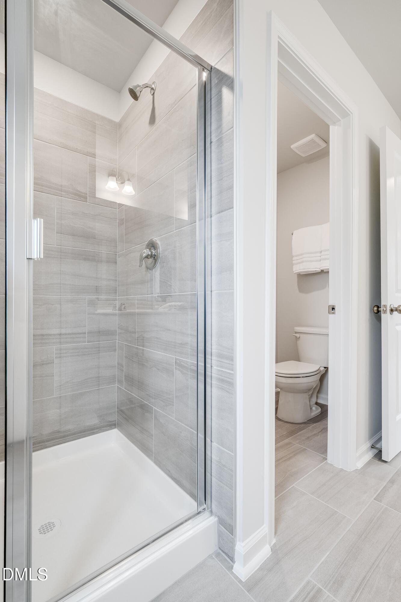 1028 Red Finch Way Angier, NC 27501 - Photo 34 of 40 a bathroom with a granite countertop bathtub shower