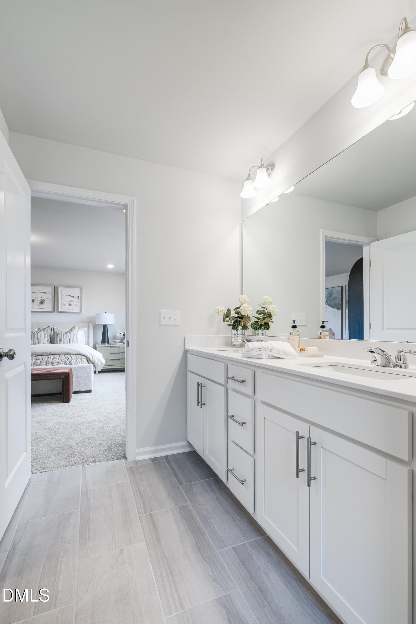 1028 Red Finch Way Angier, NC 27501 - Photo 35 of 40 a spacious bathroom with a double vanity sink and a mirror