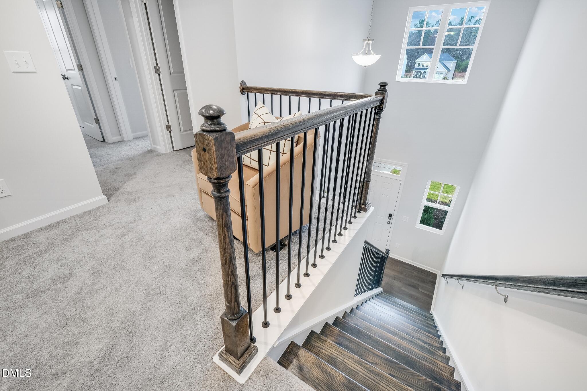 1028 Red Finch Way Angier, NC 27501 - Photo 37 of 40 a view of a hallway with wooden floor and staircase