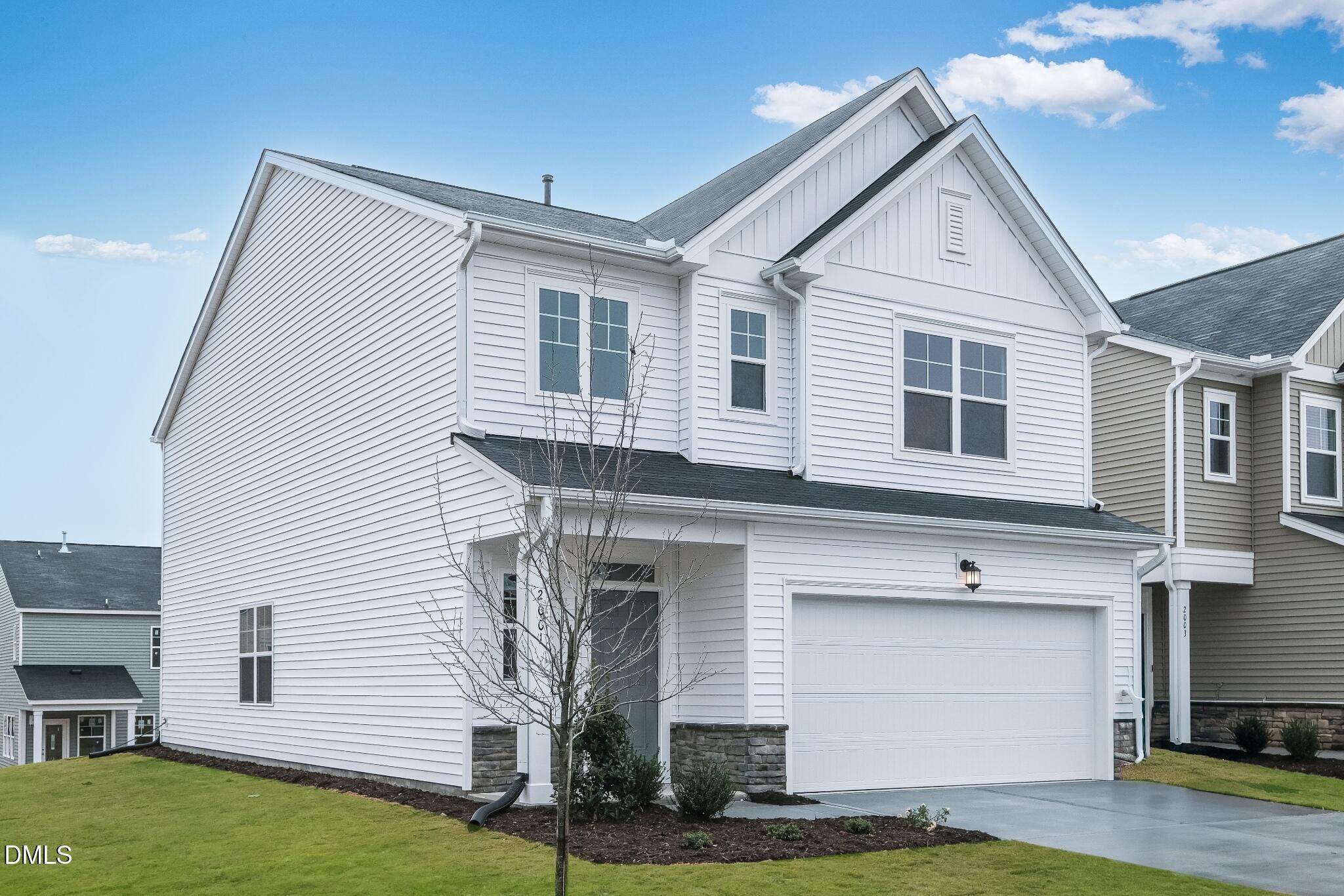 1028 Red Finch Way Angier, NC 27501 - Photo 4 of 40 a view of a white house next to a yard