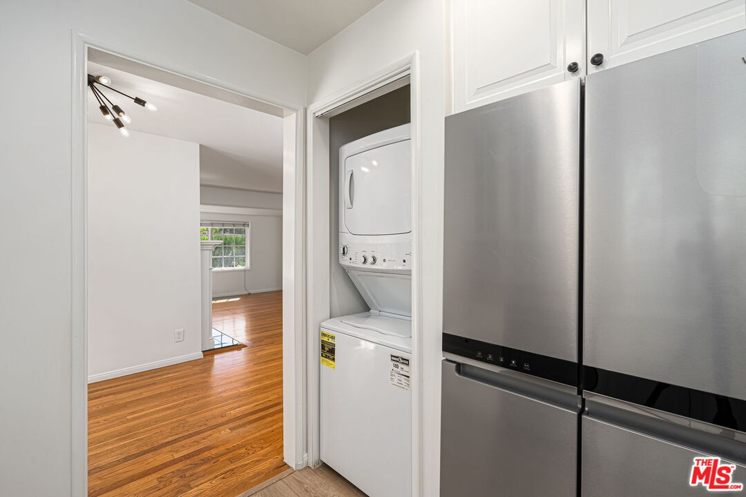 3919 South Ridgeley Drive Los Angeles, CA 90008 - Photo 12 of 23 a room with white cabinets and wooden floor