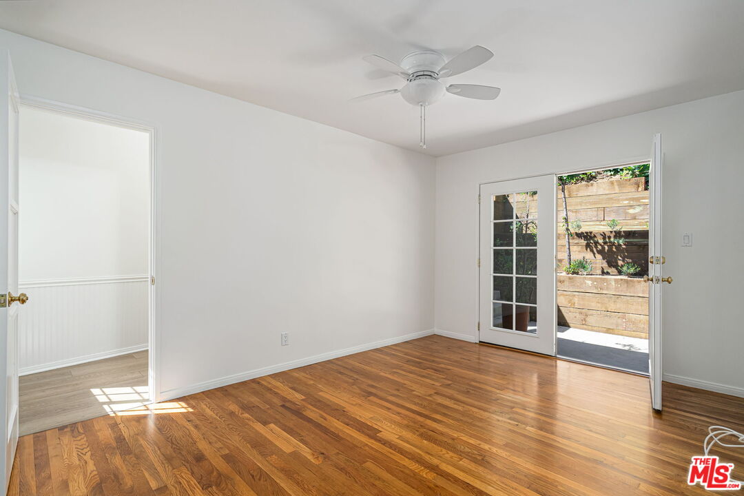3919 South Ridgeley Drive Los Angeles, CA 90008 - Photo 14 of 23 wooden floor in an empty room with a window