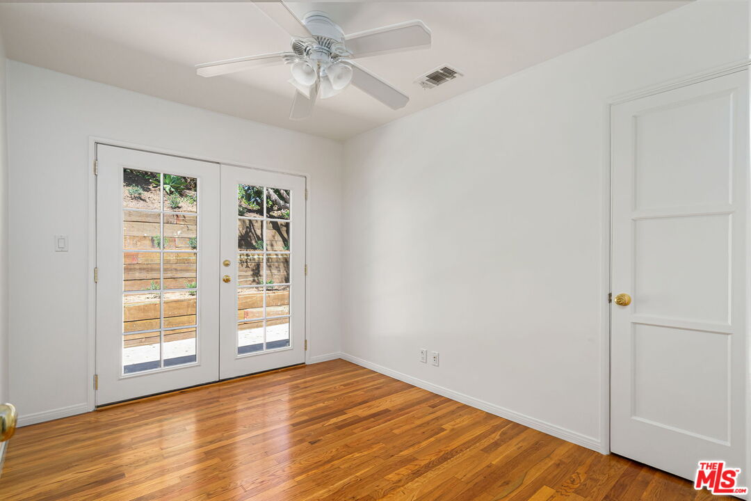 3919 South Ridgeley Drive Los Angeles, CA 90008 - Photo 15 of 23 a view of empty room with wooden floor and fan