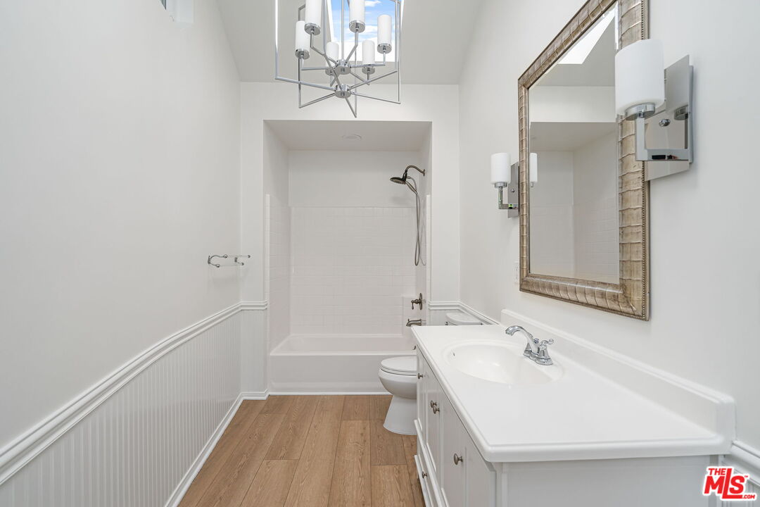 3919 South Ridgeley Drive Los Angeles, CA 90008 - Photo 18 of 23 a bathroom with a sink a toilet and shower