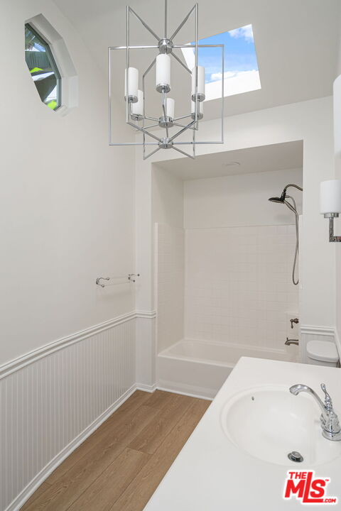 3919 South Ridgeley Drive Los Angeles, CA 90008 - Photo 19 of 23 a bathroom with a bathtub and a shower