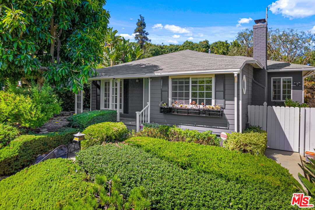 3919 South Ridgeley Drive Los Angeles, CA 90008 - Photo 2 of 23 a front view of a house with garden
