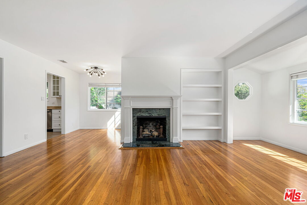 3919 South Ridgeley Drive Los Angeles, CA 90008 - Photo 6 of 23 a view of an empty room with window and fire place