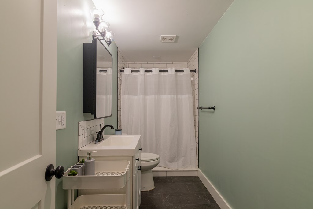 1519 1/2 16th Avenue Columbus, GA 31901 - Photo 12 of 25 a bathroom with a sink a toilet and shower