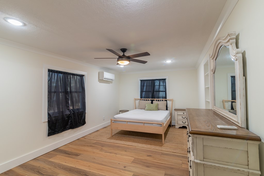 1519 1/2 16th Avenue Columbus, GA 31901 - Photo 14 of 25 a spacious bedroom with a bed and a dresser