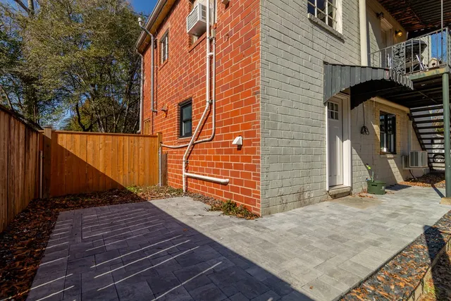 a view of a door and brick wall