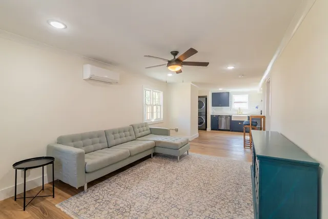 a living room with furniture and kitchen view