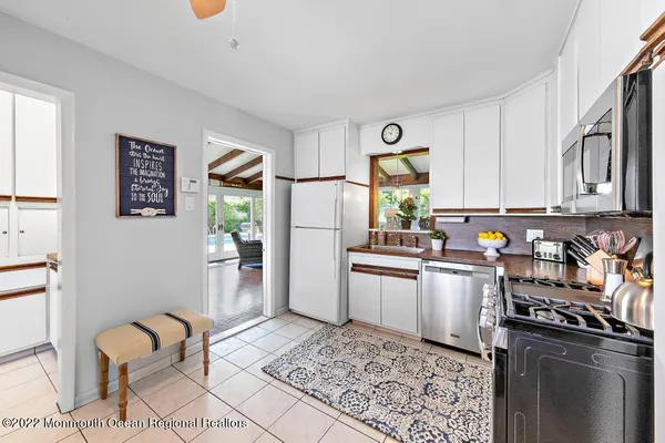 a kitchen with stainless steel appliances granite countertop a refrigerator sink and stove