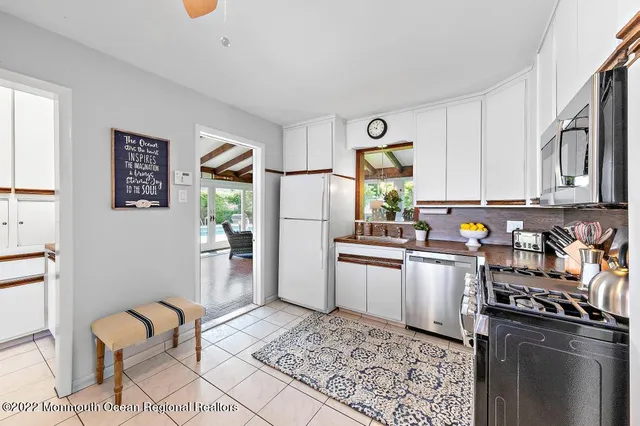a kitchen with stainless steel appliances granite countertop a refrigerator sink and stove