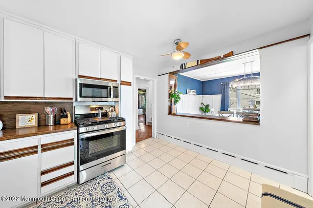 a kitchen with stainless steel appliances a stove a microwave and cabinets