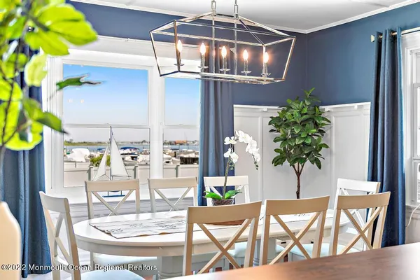 a dining room with furniture and chandelier