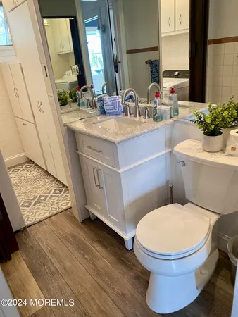 a bathroom with a sink mirror vanity and toilet