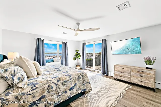 a bedroom with a large bed and a large window