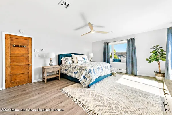 a bedroom with a bed and a potted plant