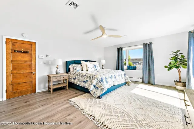 a bedroom with a bed and a potted plant