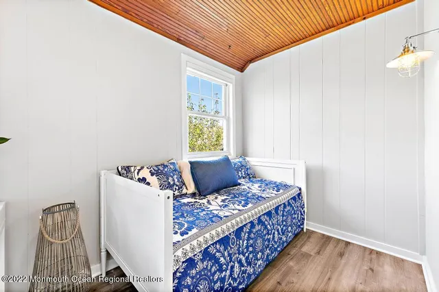 a living room with a bed and a window