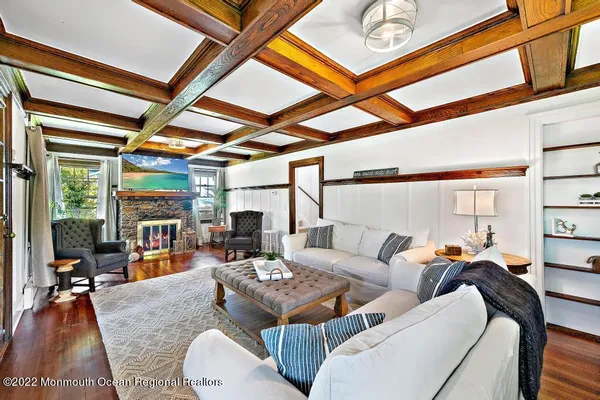 a living room with furniture and a floor to ceiling window