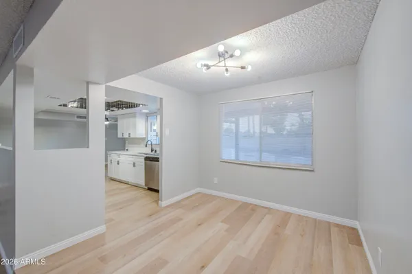 a view of a kitchen with a sink refrigerator and wooden floor